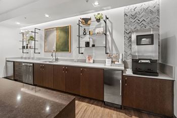 A modern kitchen with dark wood cabinets and stainless steel appliances.